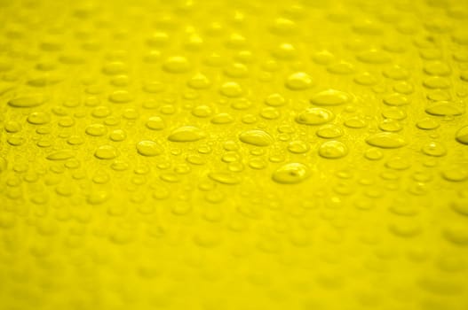 Water droplets on yellow cover background. Water droplets concept