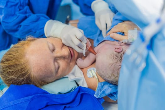 Baby on mother's chest immediately after birth in a hospital. The mother and newborn share a tender moment, emphasizing the bond and emotional connection. The medical staff ensures a safe and caring environment.