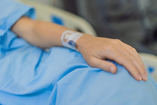 A woman in the hospital has a catheter inserted into her arm for IV drips. The medical procedure is performed to administer fluids, medication, or nutrients directly into her bloodstream, ensuring proper treatment and care.