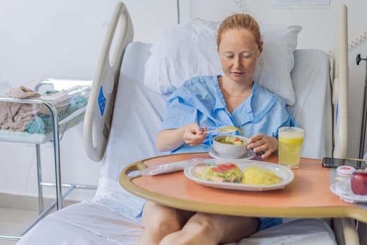 A woman after giving birth in a hospital bed eats her lunch and her baby sleeps in a crib next to her. This moment highlights the early postpartum period, focusing on maternal recovery and the peaceful presence of the newborn.