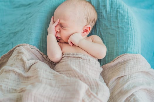 The baby is sleeping peacefully in his cozy nest. Newborn photo session captures the serene innocence and warmth of early moments.