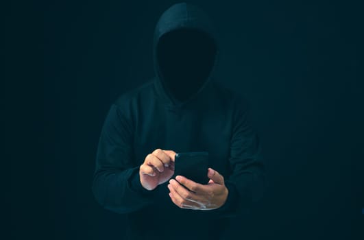 Hackers work on phone in the dark. The concept of information security in the Internet network and information espionage. Virus attack. Hacker attack.