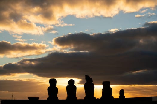 Silhouette shot of the ancient moai on Easter Island in Chile at sunset