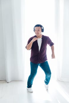 man in headphones dancing to music in the studio hall