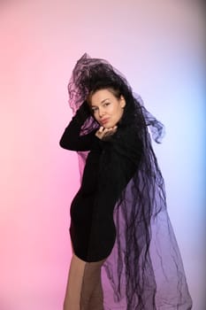 a woman in black dress with tulle in veil bride