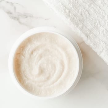 Scrub and exfoliating cream products on a marble, flatlay - skincare and body care, luxury spa and clean cosmetic concept. Health and beauty of your skin
