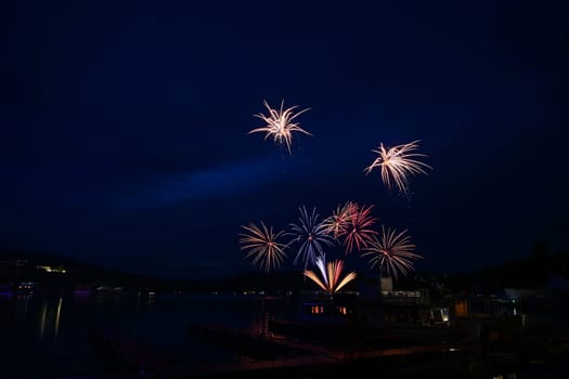 Beautiful colorful fireworks with reflections in water. Brno dam, the city of Brno-Europe. International Fireworks Competition.