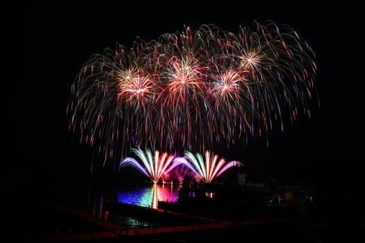 Beautiful colorful fireworks with reflections in water. Brno dam, the city of Brno-Europe. International Fireworks Competition.