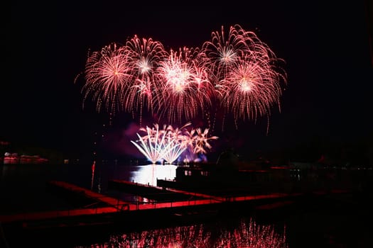 Beautiful colorful fireworks with reflections in water. Brno dam, the city of Brno-Europe. International Fireworks Competition.