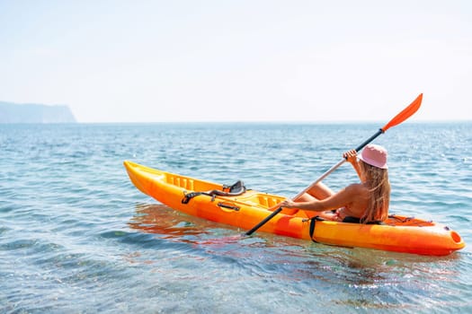 Kayak sea woman. Happy attractive woman with long hair in red swimsuit, swimming on kayak. Summer holiday vacation and travel concept