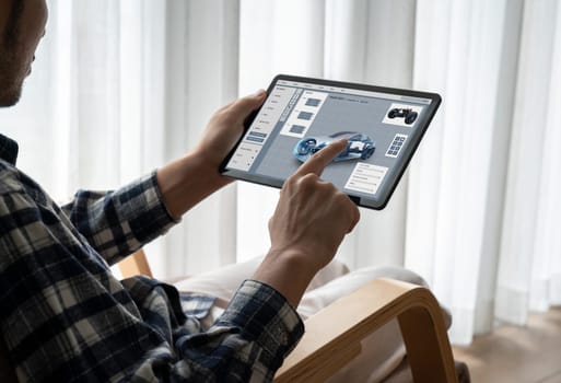 Electric car design software on computer screen showing simulation blueprint snugly by digital calculating application for manufacturing preparation