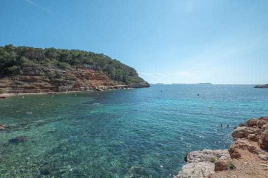 Turquoise waters of Cala Saladeta in Ibiza in summer.