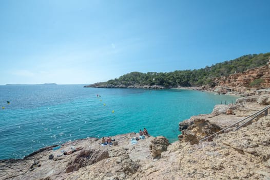 Turquoise waters of Cala Saladeta in Ibiza in summer.