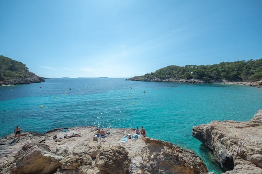 Turquoise waters of Cala Saladeta in Ibiza in summer.