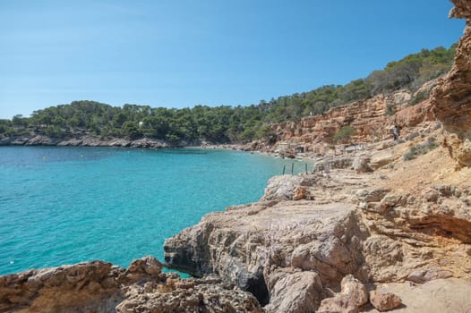 Turquoise waters of Cala Saladeta in Ibiza in summer.
