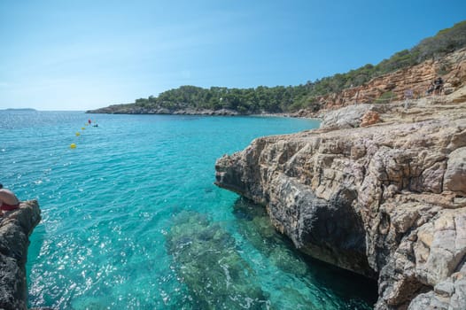 Turquoise waters of Cala Saladeta in Ibiza in summer.