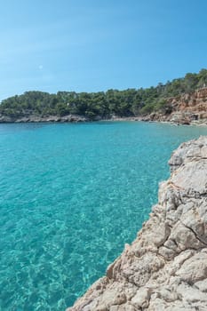 Turquoise waters of Cala Saladeta in Ibiza in summer.