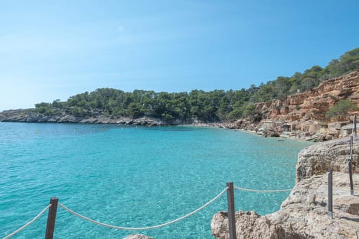 Turquoise waters of Cala Saladeta in Ibiza in summer.