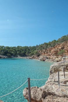 Turquoise waters of Cala Saladeta in Ibiza in summer.