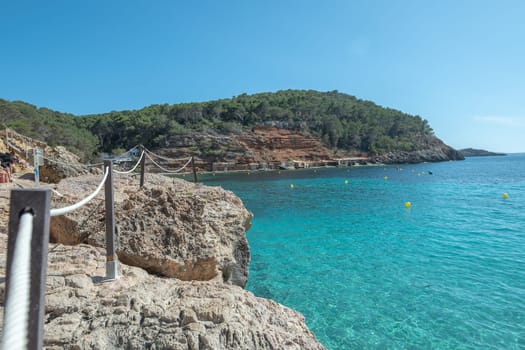 Turquoise waters of Cala Saladeta in Ibiza in summer.