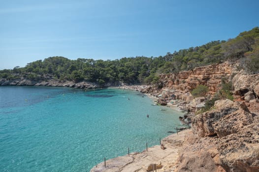 Turquoise waters of Cala Saladeta in Ibiza in summer.