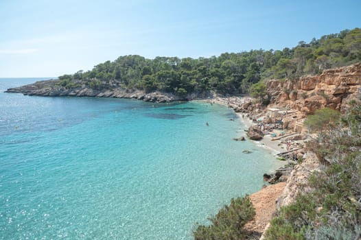 Turquoise waters of Cala Saladeta in Ibiza in summer.