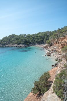 Turquoise waters of Cala Saladeta in Ibiza in summer.
