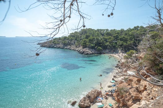 Turquoise waters of Cala Saladeta in Ibiza in summer.