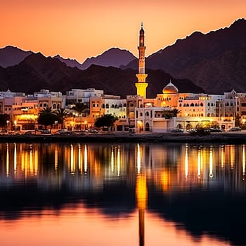 A beautiful city with a large mosque in the background. The water is calm and the sky is orange