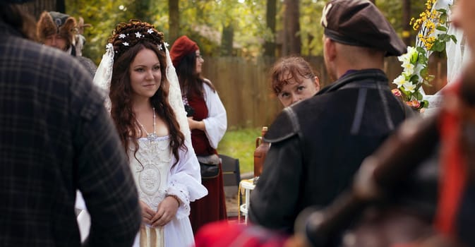 Wedding ceremony in Scotland. The bride listens to the groom's vow