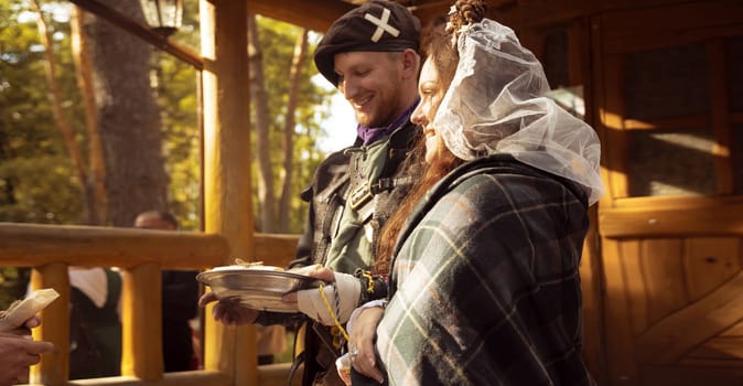 The bride and groom greet their guests with treats. Scottish wedding