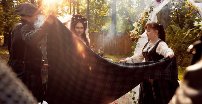 Wedding ceremony. Scottish wedding. Husband and wife are connected by the threads of fate.