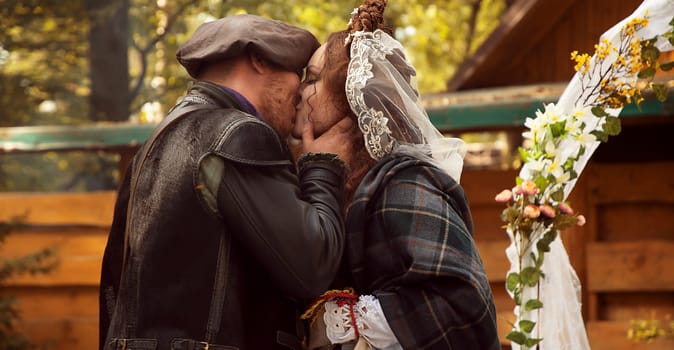 The groom kisses his bride. Scottish wedding. High quality photo