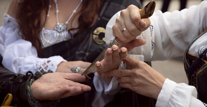Cutting the palm with a knife. The Tradition of the Oath.Blood Oath. High quality photo