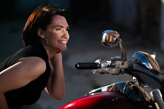 Brunette woman looks in the rearview mirror on a motorcycle