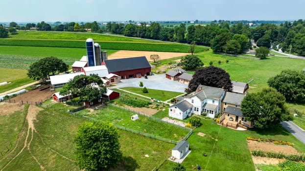 Paradise, Pennsylvania, USA, July 18. 2023 - An Aerial View of a Farmstead with Barns and Green Fields