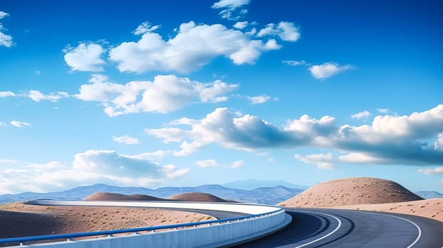 A long, empty road with a mountain range in the background. The sky is cloudy and the sun is shining through the clouds