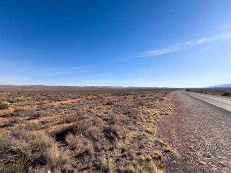 A long, deserted road stretches towards distant mountains in Ikara Flinders Ranges