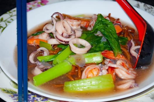 Gravy noodle served with seafood. Asian food concept
