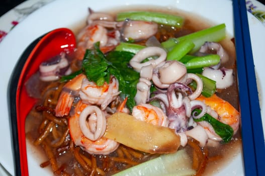 Close up view of Gravy noodle served with seafood. Asian food concept.