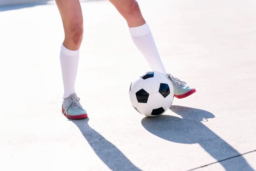 close up of the feet of a football player playing with a soccer ball, concept of sport and active lifestyle