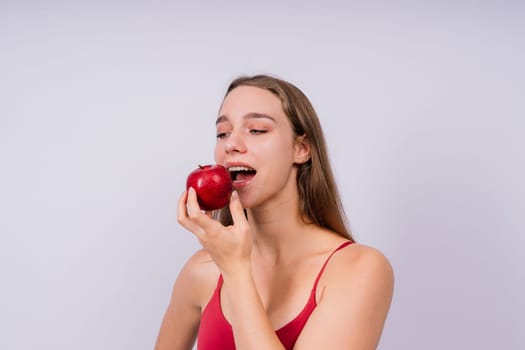 Cropped of sporty female with well fit body holding an apple, healthy food and fit body concept