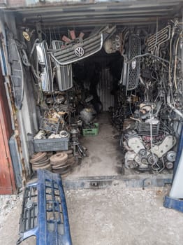 freight container filled with used car parts on junkyard shop in Kudaybergen, Bishkek, Kyrgyzstan - March 20, 2023