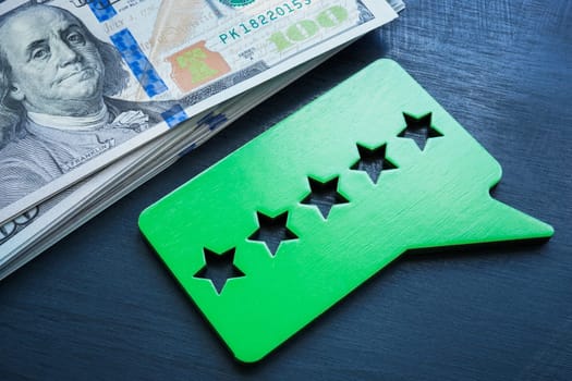 Money and a plate with five stars rate. Performance based pay.