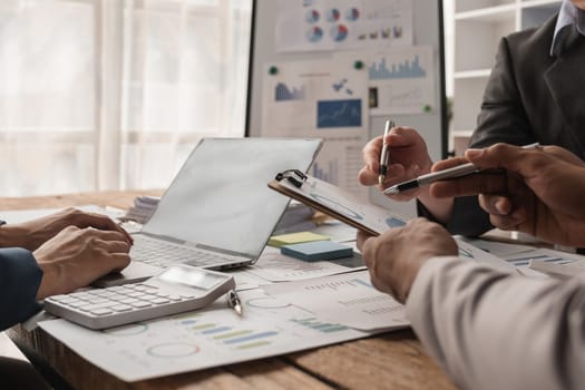 A business team working together, analyzing financial reports and discussing strategies in a modern office environment.