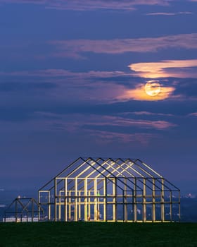 NEUKIRCHEN-VLYN, GERMANY - MAY 5, 2023: Norddeutschland tip, landmark of Ruhr Metropolis against night sky with moon on May 5, 2023 in Neukirchen-Vlyn, Germany