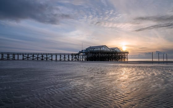 SANKT PETER ORDING, GERMANY - MARCH 8, 2023: Panoramic image of beach houses of Sankt Peter Ording close to the North Sea on March 8, 2023 in North Frisia, Germany