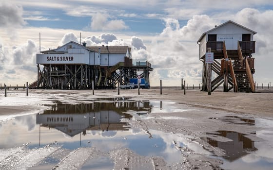 SANKT PETER ORDING, GERMANY - MARCH 8, 2023: Panoramic image of beach houses of Sankt Peter Ording close to the North Sea on March 8, 2023 in North Frisia, Germany