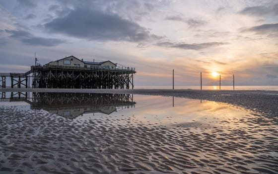 SANKT PETER ORDING, GERMANY - MARCH 8, 2023: Panoramic image of beach houses of Sankt Peter Ording close to the North Sea on March 8, 2023 in North Frisia, Germany