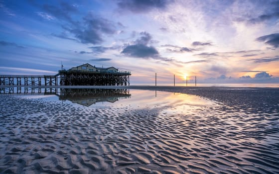 SANKT PETER ORDING, GERMANY - MARCH 8, 2023: Panoramic image of beach houses of Sankt Peter Ording close to the North Sea on March 8, 2023 in North Frisia, Germany